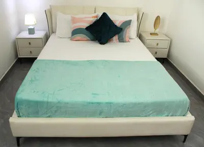 a bedroom with a large bed with blue sheets and pillows at APARTAMENTO T2 - SAL REI - Boa Vista in Sal Rei