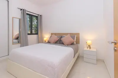 a white bedroom with a bed and a window at Brand New Spacious T3 Apartment in Santa Maria in Santa Maria