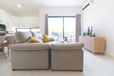 a living room with a couch and a table at Brand New Spacious T3 Apartment in Santa Maria in Santa Maria