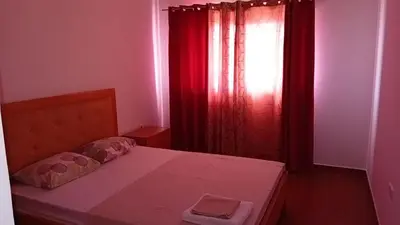 a small bedroom with a bed and a window at Elite Residences MVT in Praia
