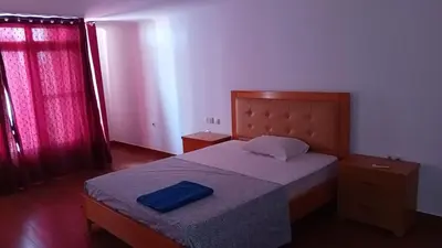 a bedroom with a bed with a blue pillow on it at Elite Residences MVT in Praia