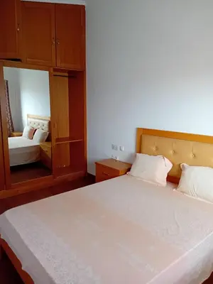 a bedroom with a large white bed and a mirror at Elite Residences MVT in Praia