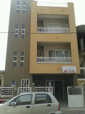 a car parked in front of a building with balconies at DMSilva in Praia