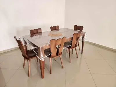 a dining room table with wooden chairs and a silver table and chairsktop at DMSilva in Praia