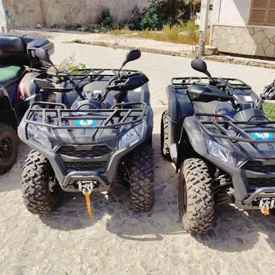 two atvs parked next to each other on a street at Pensão Big Game Maio Vila do Maio in Vila do Maio