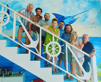a painting of a group of people on a staircase at Pensão Big Game Maio Vila do Maio in Vila do Maio