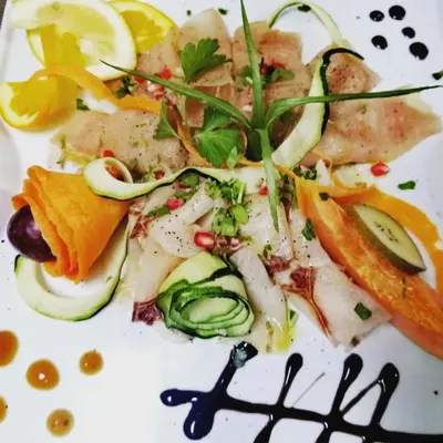 a white plate of food with fish and vegetables at Pensão Big Game Maio Vila do Maio in Vila do Maio