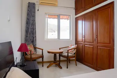 a room with a table and chairs and a window at Bungavília house, Palmarejo in Praia