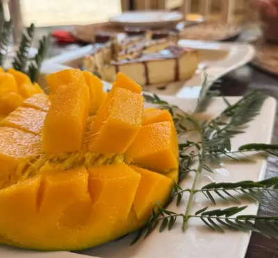 a plate filled with slices of fruit on a table at Pensao Porta do Vento in Santa Maria
