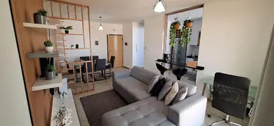 a living room with a couch and a dining room at Sinta-se em casa! in Praia