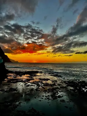 a sunset over the ocean with a reflection in the water at Casa Branca in Ponta do Sol