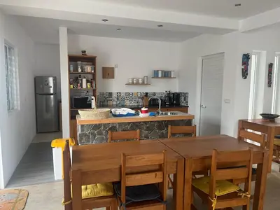 a kitchen with a wooden table and a kitchen with a counter at Casa Branca in Ponta do Sol