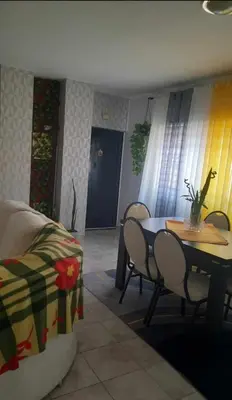 a living room with a table and a table and chairs at Apartamento Mi in Praia