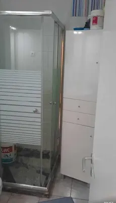 a glass shower in a bathroom with a white cabinet at Apartamento Mi in Praia