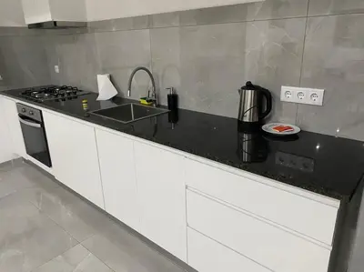 a kitchen with a black counter top and a stove at Casa Nelly & Toi JB in Tarrafal