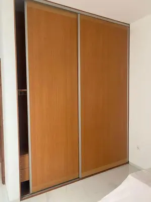 a pair of wooden closet doors in a room at Casa Nelly & Toi JB in Tarrafal