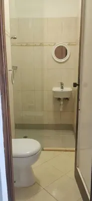 a bathroom with a toilet and a sink at Sunset Plateau in Praia