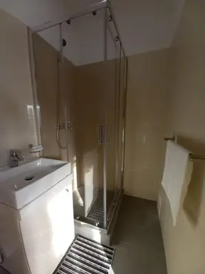 a bathroom with a glass shower and a sink at One cozy bedroom - Studio in Santa Maria in Santa Maria