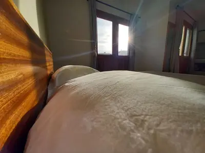 a white bed in a room with a window at One cozy bedroom - Studio in Santa Maria in Santa Maria