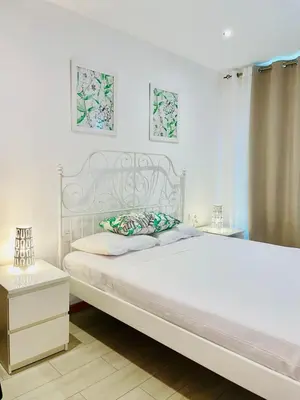 a white bedroom with a white bed and a white dresser at Sal Little Heart Apartment 21 in Santa Maria