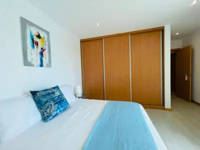 a bedroom with a large bed with a wooden closet at Sal Little Heart Apartment 21 in Santa Maria