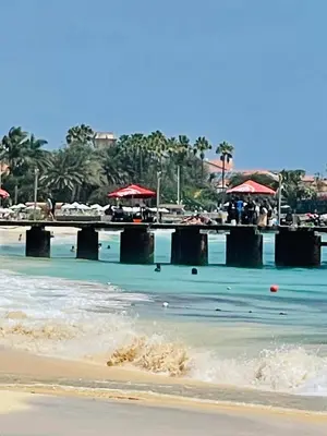 a beach with red umbrellas and the ocean at Sal Little Heart Apartment 21 in Santa Maria