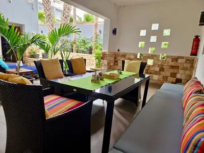 a dining room with a table and chairs at Zweite Heimat - Townhouse Boa Vista in Sal Rei