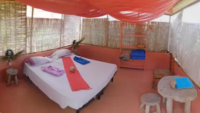 a bedroom with a bed with a red towel on it at Tortuga B&B in São Filipe