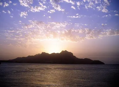 a sunset over an island in the ocean with the sun setting at Casa Monte Cara T2 in Lazareto