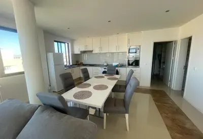 a kitchen and dining room with a table and chairs at Casa Monte Cara T2 in Lazareto