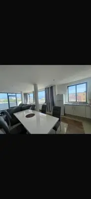 a living room with a white table and chairs at Casa Monte Cara T2 in Lazareto