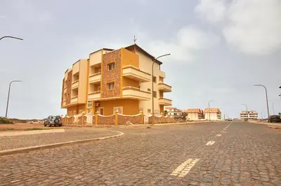 a yellow building on the side of a road at La Piazza in Santa Maria