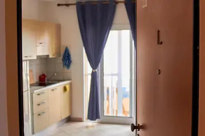 a kitchen with a sliding glass door to a patio at La Piazza in Santa Maria