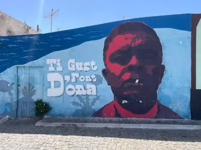 a mural of a man painted on a wall at Flor de Sal Apartment in Santa Maria
