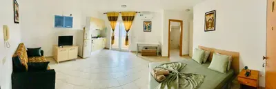 a living room with a couch and a tv at Flor de Sal Apartment in Santa Maria