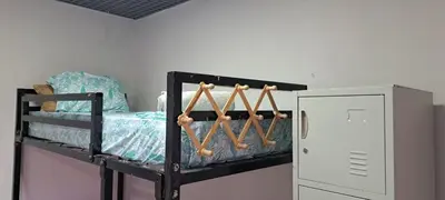 a black bunk bed with baseball bats and a locker at Mendes Family Guesthouse, and Services in Praia