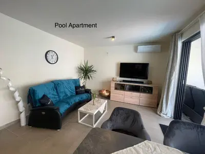 a living room with a blue couch and a tv at Luxury Paradise Beach Lagoon in Sal Rei