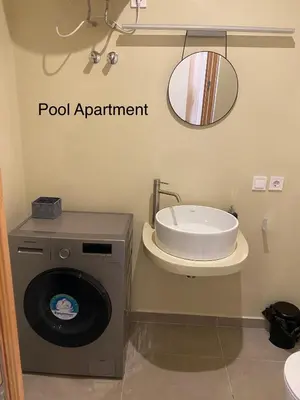 a bathroom with a washing machine and a mirror at Luxury Paradise Beach Lagoon in Sal Rei