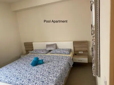a bedroom with a bed with blue pillows and a mirror at Luxury Paradise Beach Lagoon in Sal Rei