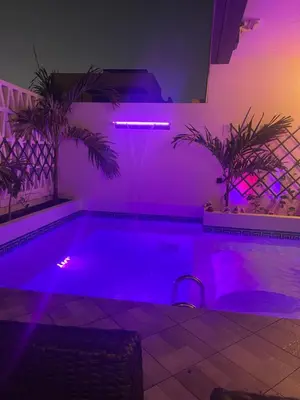 a swimming pool with purple lights in a room at Luxury Paradise Beach Lagoon in Sal Rei