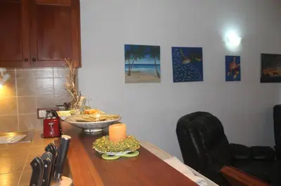 a dining room table with a candle on top of it at Casa Mar Doce in Sal Rei
