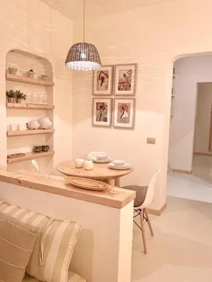 a kitchen with a table and chairs and a chandelier at Casa da Leoa in Sal Rei