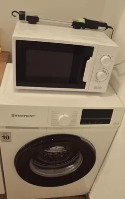 a microwave oven sitting on top of a washing machine at My Boavista 1 in Sal Rei