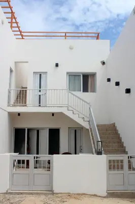 a white house with stairs and a stair case at My Boavista 1 in Sal Rei
