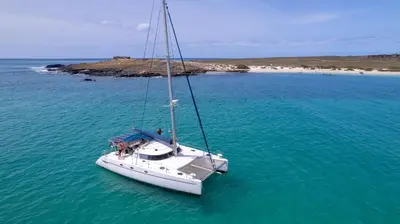 a boat in the water with two people on it at My Boavista 1 in Sal Rei