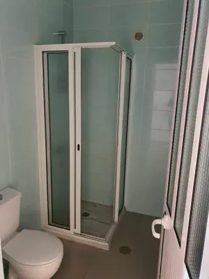 a bathroom with a toilet and a glass shower at Elizabeth Rocha in Mindelo