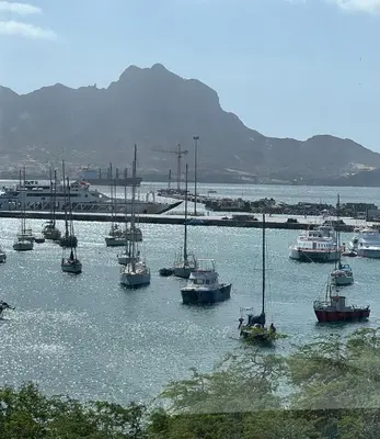 a group of boats sitting in the water at Apartamentos Baia Marginal 1 in Mindelo
