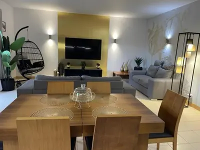 a living room with a dining table and a couch at Cactus Gold Vila Verde in Santa Maria