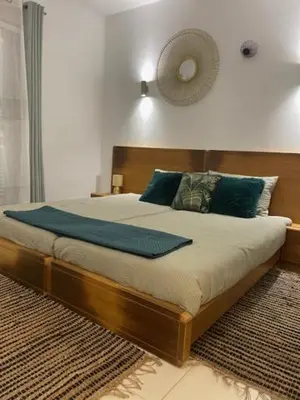 a bedroom with a large bed with blue pillows at Cactus Gold Vila Verde in Santa Maria