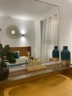 a room with a bedroom with a bed and a mirror at Cactus Gold Vila Verde in Santa Maria